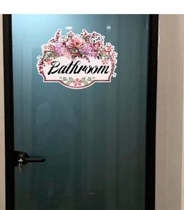 Detail view of floral bathroom door sticker with pink and purple flowers and text