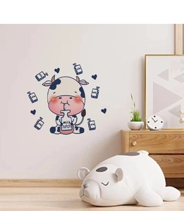 Detail showing cartoon cow wall stickers with milk bottles for cozy nursery room decoration