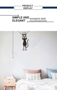 Detail showing creative black cat wall sticker with funny climbing posture for home decor