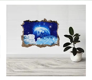 Detail view of 3D galaxy wall sticker with blue planet and stars on a white brick wall