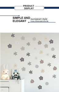 Detail of Morandi style floral and star wall stickers in a cozy Nordic nursery room