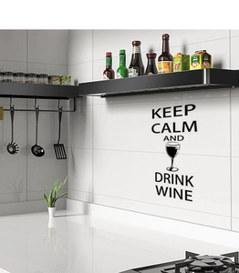 Detail of Keep Calm and Drink Wine vinyl wall decal on a modern kitchen tile surface