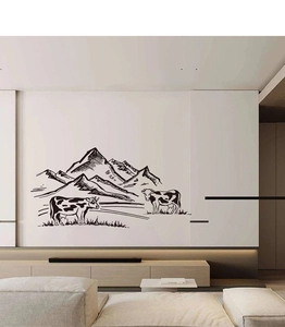 Minimalist farmhouse wall sticker with mountain and cow sketch on a living room wall