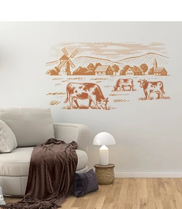 Detail of pastoral wall sticker featuring a cow and windmill over a gray sofa