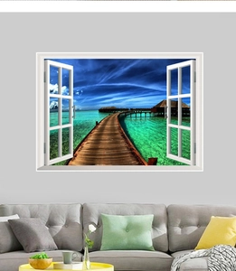 Detail showing 3D ocean view wall sticker with white window frame over gray sofa