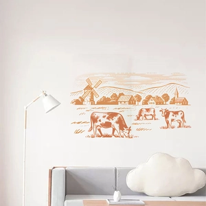 European farmhouse wall decal featuring cows and windmill above a modern gray sofa
