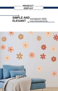 Detail of colorful floral wall stickers in orange and yellow on a living room wall