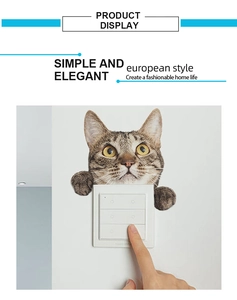 Close-up of a cute cat wall sticker peeking behind a standard white light switch cover
