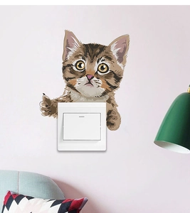 Close-up of cute cat wall sticker showing interactive 3D effect around a light switch
