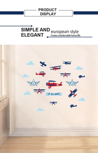 Detail of vintage biplane wall stickers with blue clouds and red aircraft decals