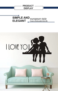Macro detail of I LOVE YOU wall sticker featuring silhouettes of a couple on a white wall