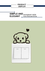 Detail of cute cartoon dog wall sticker placed above a white light switch panel