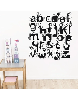 Creative 26 black monster alphabet wall stickers in a cozy nursery room setting