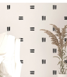 Détail de stickers muraux minimalistes noirs à trois lignes sur fond beige clair