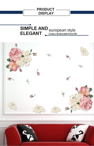 Detail display of pink floral wall stickers on white wall above a red sofa decor