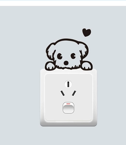 Detail of creative cartoon dog wall sticker with heart applied on a white light switch
