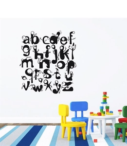 Close-up of 26 creative black monster alphabet wall decals in a playroom setting