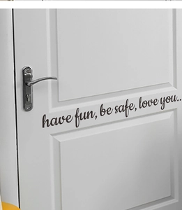 Close-up of black Have Fun Be Safe vinyl wall sticker on a white wooden door decor