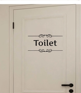 Autocollant de porte de toilettes en vinyle noir avec motifs élégants sur porte blanche