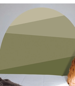 Detail of bohemian arch wall sticker with layered green mountain design in a bedroom