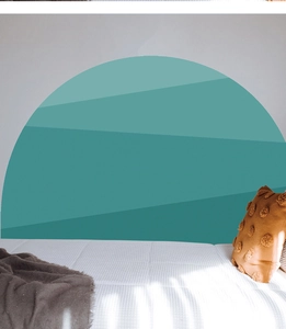 Close-up of bohemian semi-circle wall decal with layered teal geometric patterns