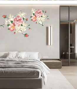 Detailed view of pink rose and floral wall decals applied on a grey bedroom wall