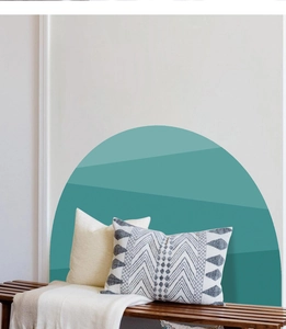 Detail view of semi-circle mountain wall decal in a minimalist living room setting