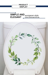 Detail showing self-adhesive floral wreath decal on a white toilet lid in a modern bathroom