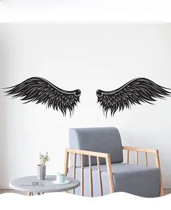Detail showing matte black wing wall decals with fine feather texture on a white wall