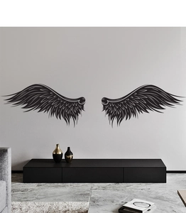 Detail of minimalist black angel wing wall stickers on a modern living room wall