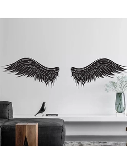 Detail of minimalist black sketch wings wall decal in a modern living room setting