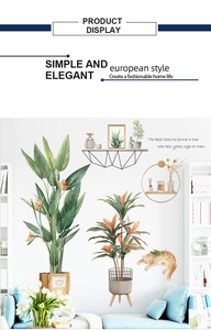 Detail showing tropical green leaf wall stickers with a sleeping cat and quote