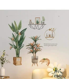 Detail of tropical plant wall decals with cat and motivational quote in a Nordic style room