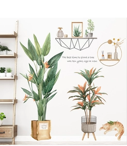 Detail of tropical plant wall stickers with a sleeping orange cat and motivational text