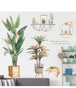 Detail of tropical plant wall decals featuring green leaves and a cat for home decor