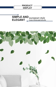 Detailed view of elegant green leaf wall stickers in a minimalist living room setting
