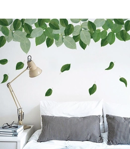 Detail of green leaf wall stickers with delicate white flowers for modern bedroom decor