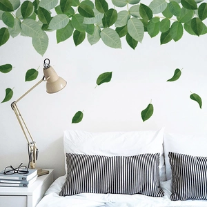 Green leaf wall decals for home decor made of waterproof PVC on a white bedroom wall