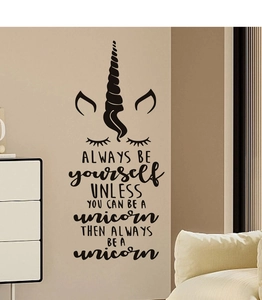 Detailed view of unicorn wall decal with motivational quote on a home interior wall