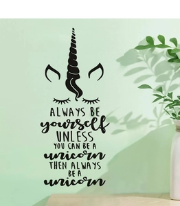 Detail of creative unicorn wall decal with inspirational quotes on green wall background