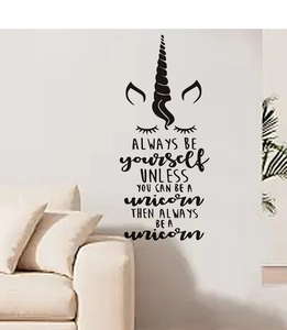 Detail of black unicorn wall decal with motivational quotes on a white bedroom wall