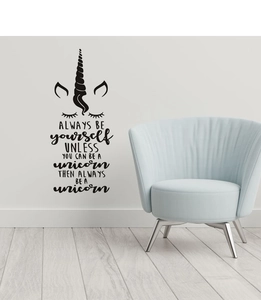 Detail of unicorn wall decal with inspirational quote on a white bedroom wall