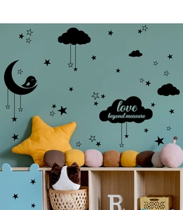 Detailed view of moon and stars wall decals with love beyond measure quote in a bedroom