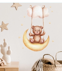 Detail of watercolor teddy bear on moon swing wall decal in a cozy nursery room