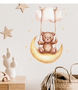 Detail showing a watercolor baby bear on a moon swing wall decal for a nursery room