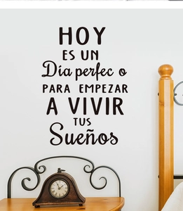 Macro shot of black Spanish motivational wall decal on a white bedroom wall surface