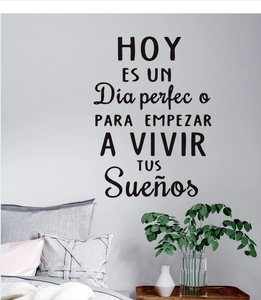 Detailed view of Spanish inspirational quote wall sticker on a minimalist bedroom wall