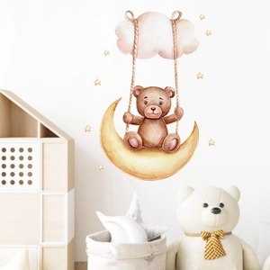 Nursery wall sticker featuring a bear on a crescent moon swing with clouds and stars