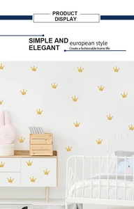 Close-up of golden glitter crown wall stickers in a minimalist children's bedroom decor