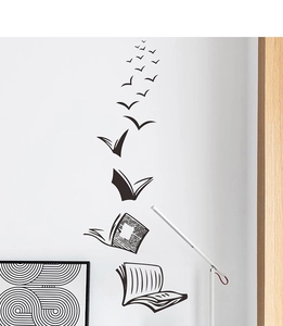 Detail of creative black vinyl wall decal featuring books transforming into flying birds
